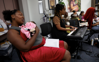 A woman sings a lullaby to her baby